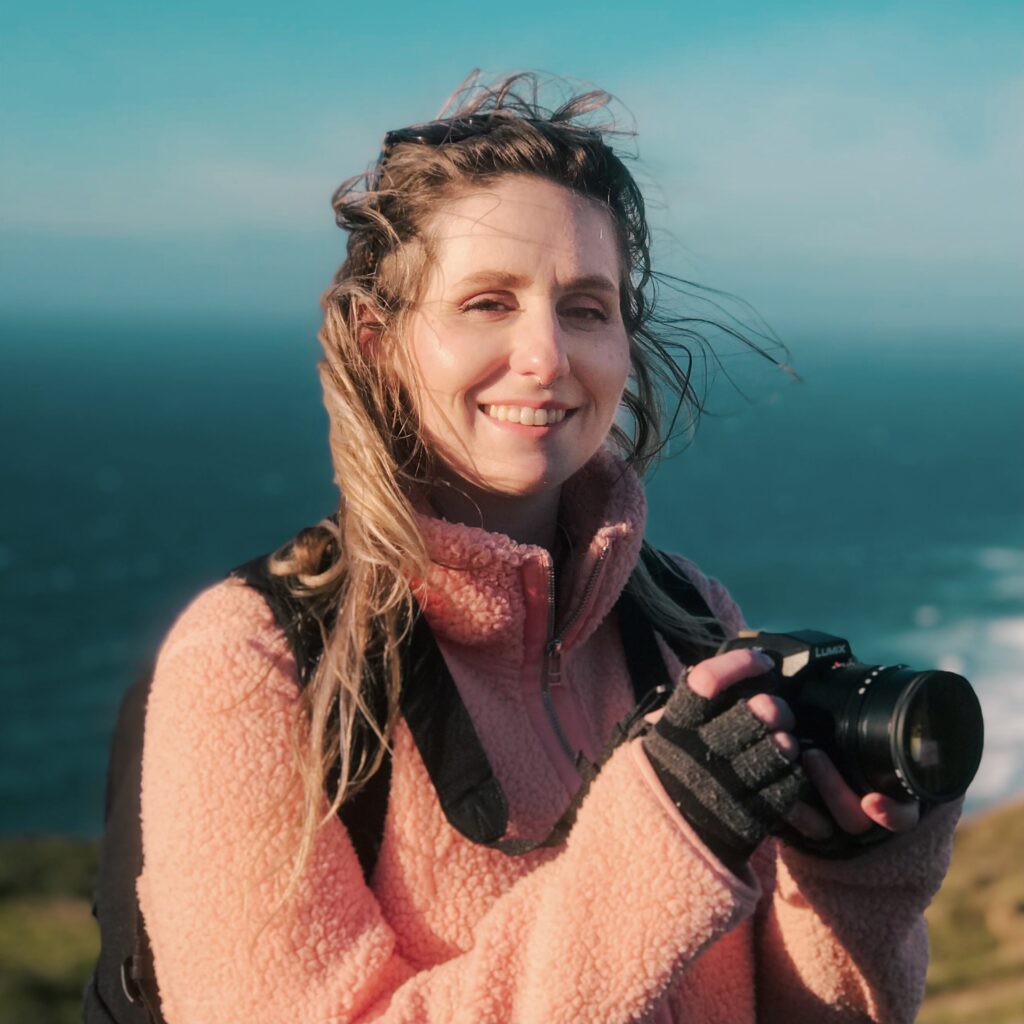 Photographer posing for camera near the coast