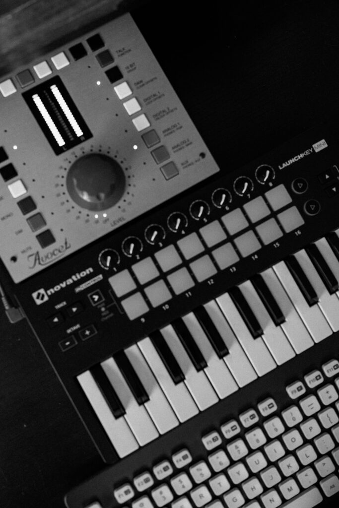 Overhead view of MIDI controller and synth gear in modern studio