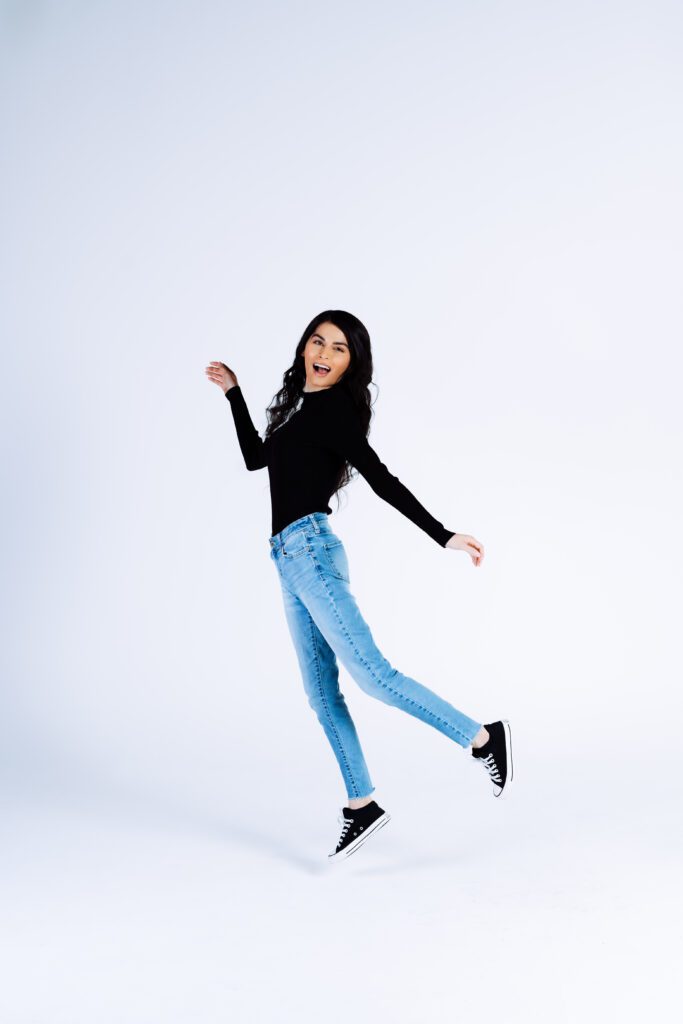 Expressive photo of a woman jumping mid-movement—highlighting freedom and fun for brand photography.