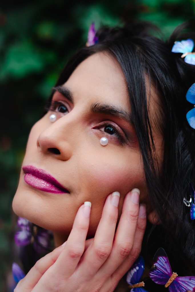Detailed beauty headshot with pearl makeup, butterfly hair styling, and soft expression—perfect for a fantasy-inspired brand portrait session.
