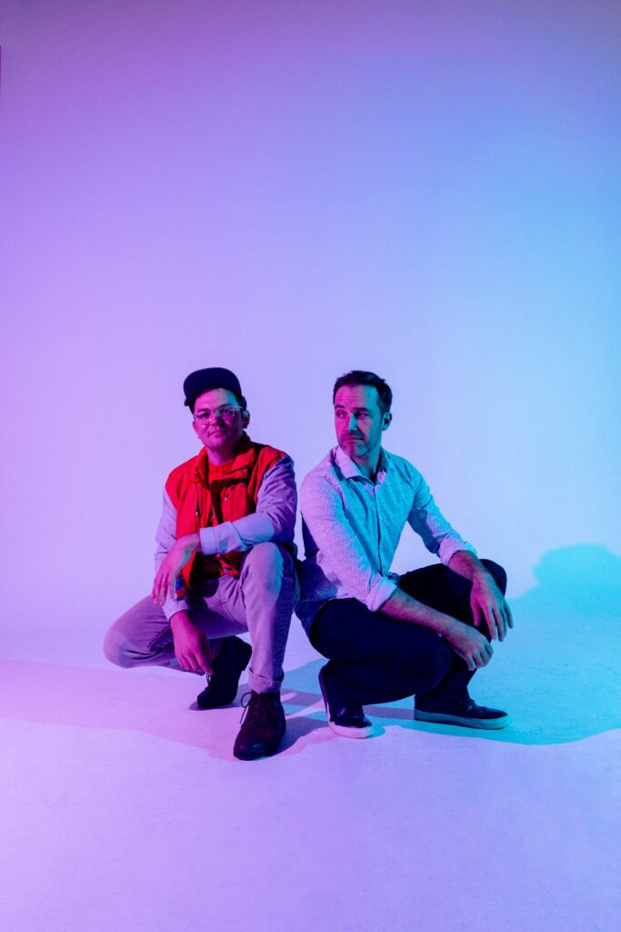 Portland-based electronic music duo Househusband posing in a neon-lit studio during their creative brand session with Mewphotovideo