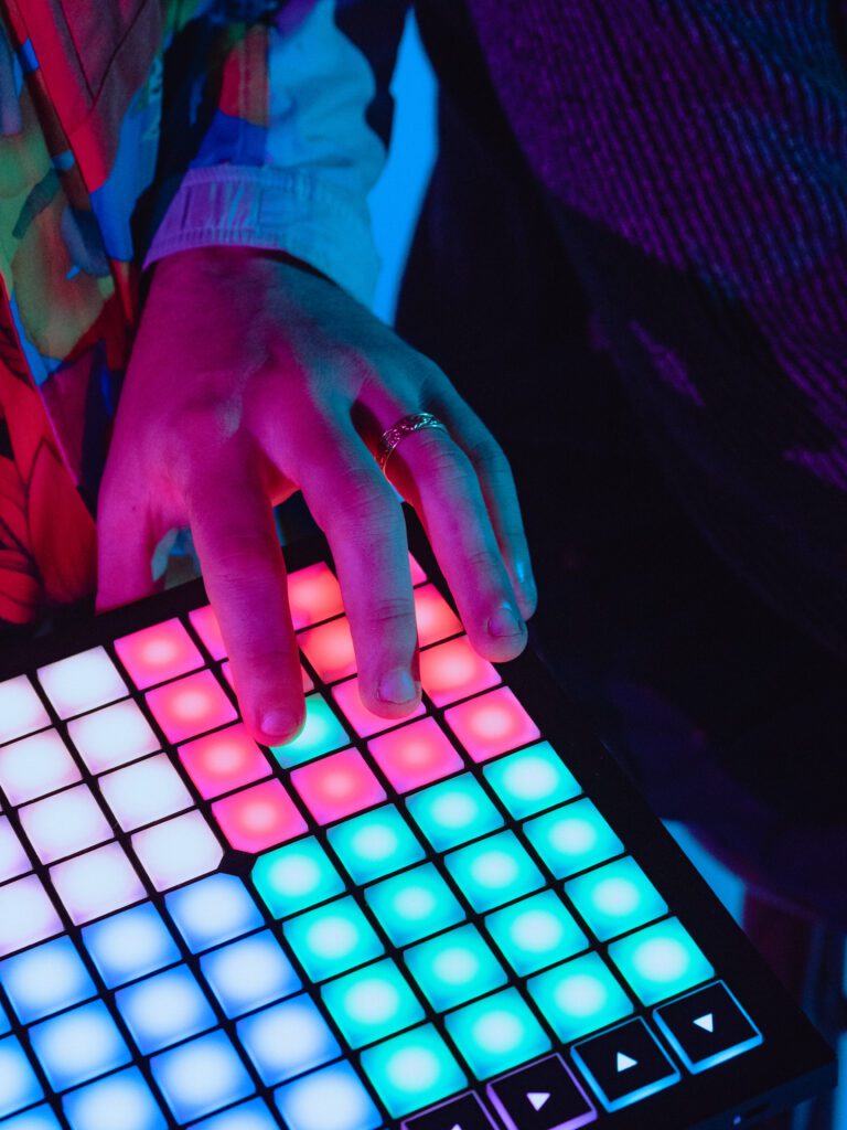 Househusband band member using a colorful beat pad during a branding shoot for music artists at The Studio Lab in Portland