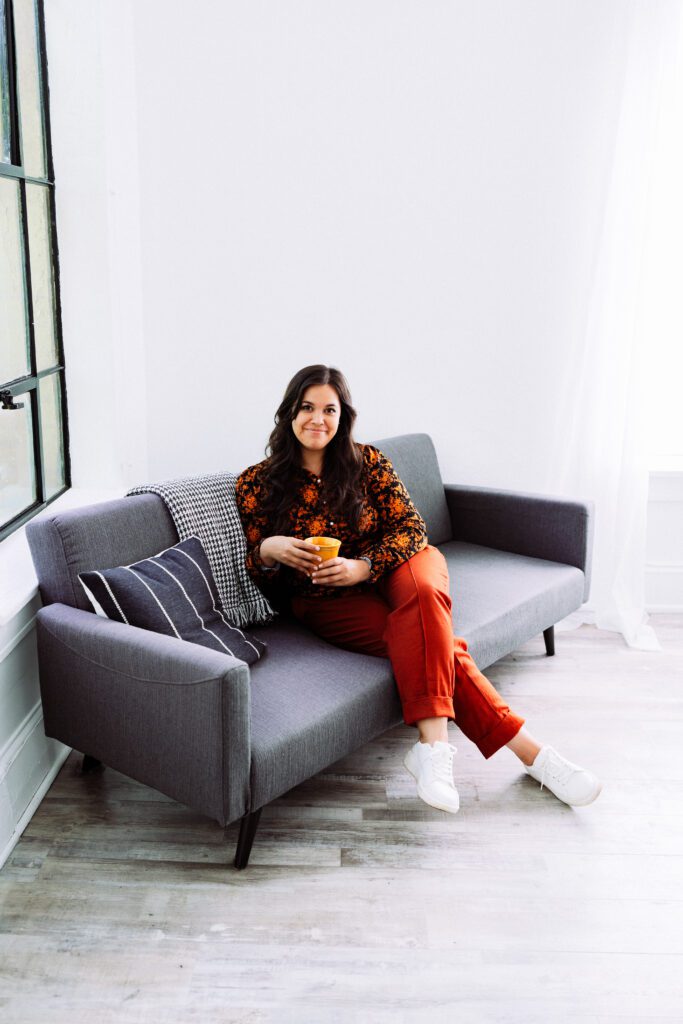 Personal brand photo of a musician holding a mug in a clean modern studio space during her creative shoot
