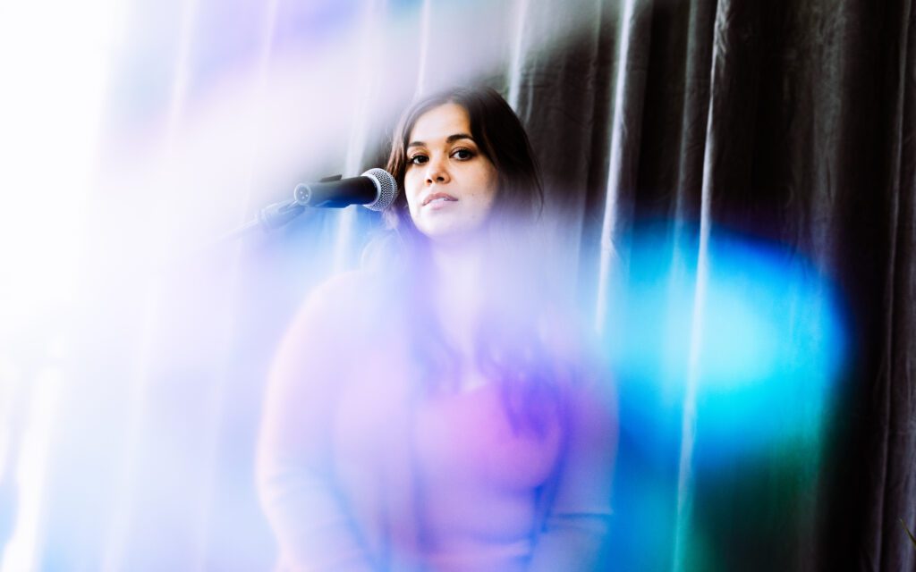 Singer-songwriter in soft, hazy studio light during a moody and expressive brand photoshoot