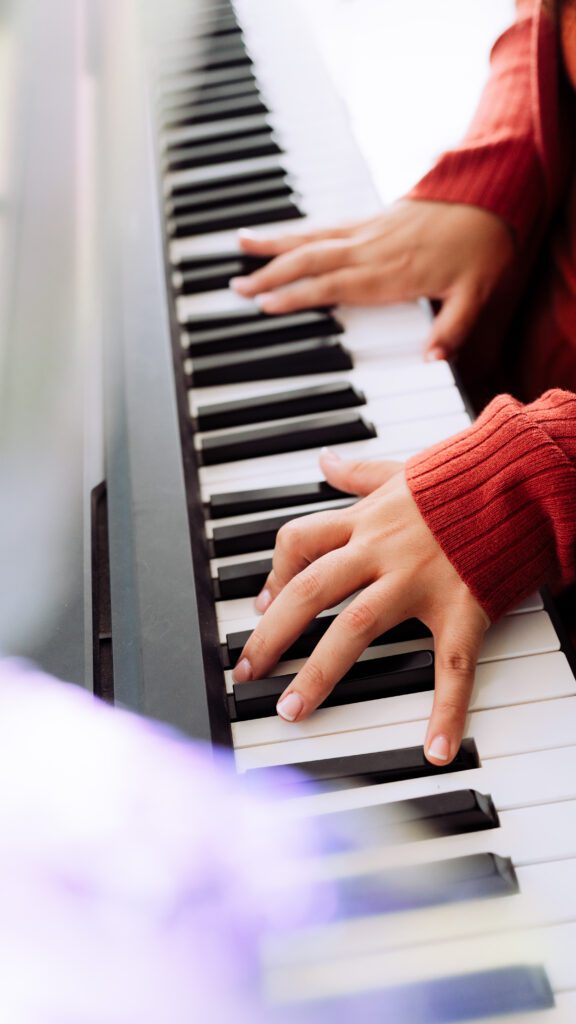 Close-up of musician’s hands playing keyboard in a personal branding session for artists