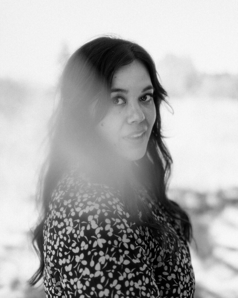 Black and white editorial-style headshot photo of an artist candid look towards camera during a Portland brand session