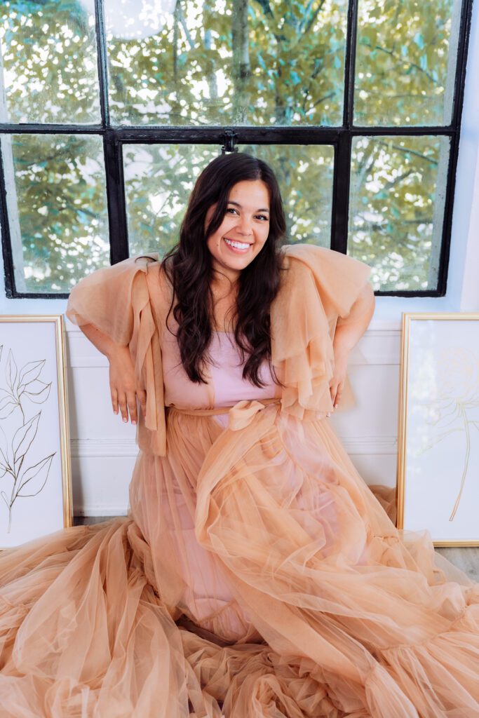 Creative brand portrait of a musician smiling in soft daylight wearing a romantic layered dress