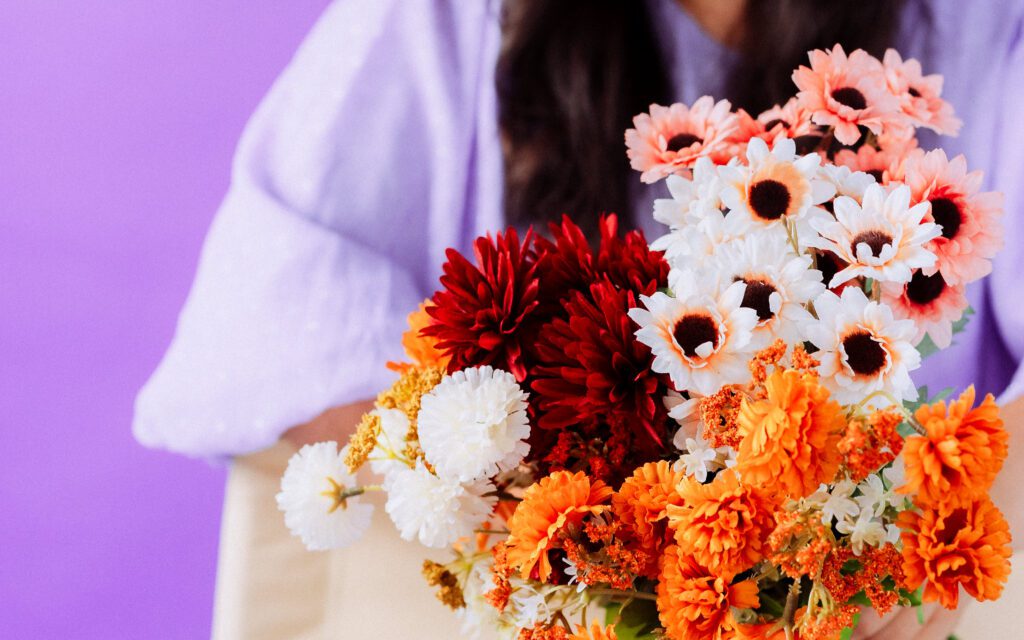 Close-up of bright orange and white flowers styled for a musician's personal branding photoshoot