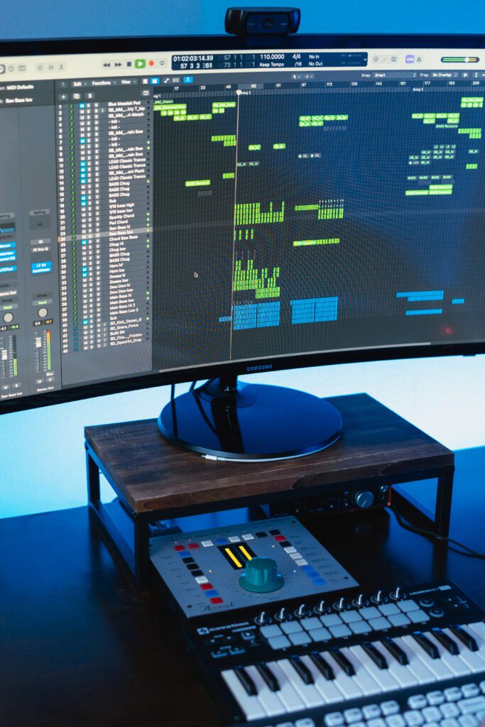 Electronic track in progress with layers and waveforms on studio screen