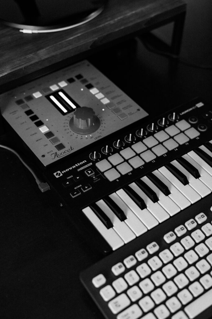 Monochrome photo of synth pad and keyboard in home recording setup
