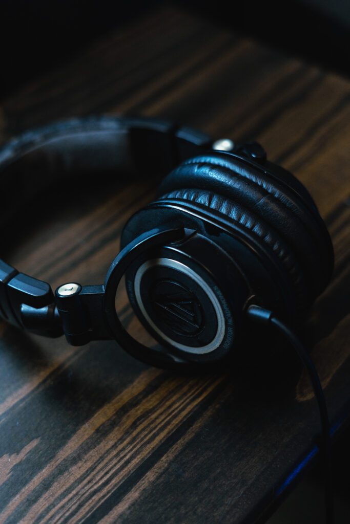 Artistic close-up of coiled audio headphones in music production setup