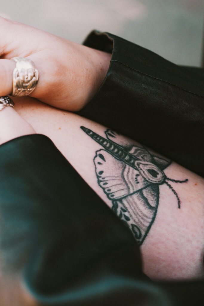 Artistic close-up of an arm tattoo and leather sleeve, highlighting personal style during a Portland portrait photo shoot.
