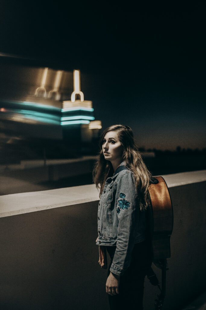 Singer songwriter Morgalily poses candid on a rooftop at dusk